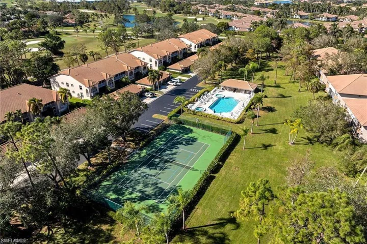 Aerial view of a pool area and a nearby body of water