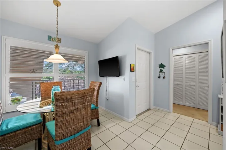 Dining room with lofted ceiling and light tile patterned floors