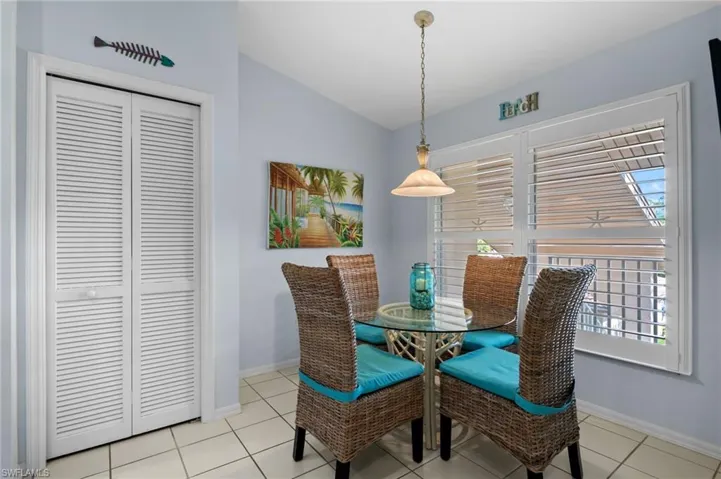 Dining area featuring lofted ceiling and light tile patterned floors