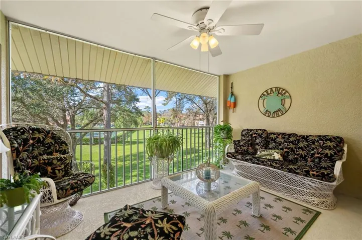 Sunroom featuring a textured wall and carpet