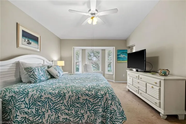 Bedroom with light carpet and ceiling fan