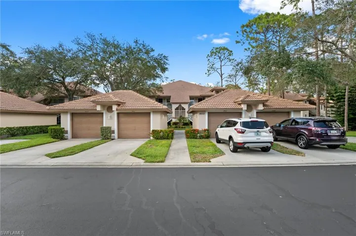 Mediterranean / spanish-style house featuring stucco siding, a tile roof, driveway, and a garage