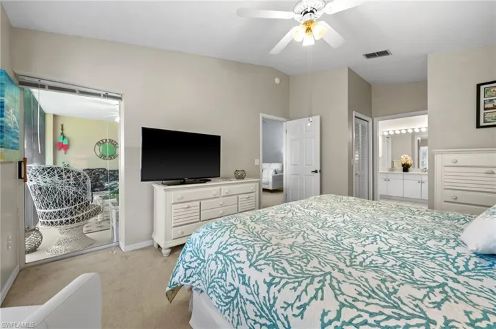 Bedroom featuring light colored carpet, access to exterior, and a ceiling fan