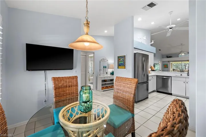 Kitchen with a ceiling fan, light tile patterned floors, light countertops, white cabinets, and recessed lighting
