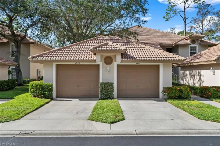 Mediterranean / spanish house featuring stucco siding, a garage, driveway, and a tiled roof