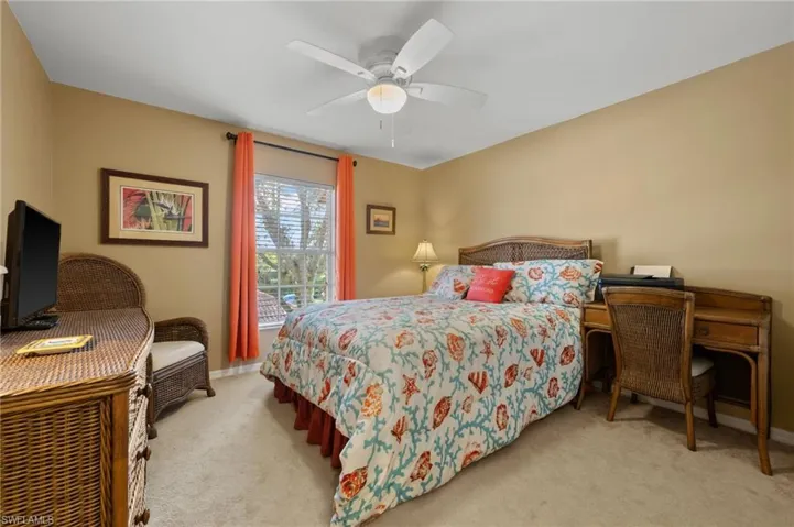 Bedroom featuring light carpet and a ceiling fan
