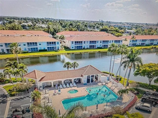 Community pool featuring a patio area and a water view
