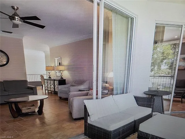 Living room featuring a ceiling fan and plenty of natural light
