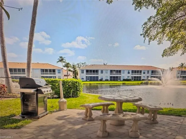 View of home's community with a water view and a patio