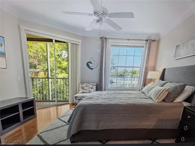 Bedroom with light wood finished floors, access to outside, and a ceiling fan
