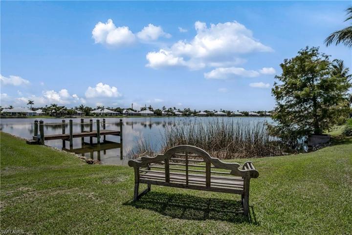 Wooden Bench and view of lake and neighbor's dock
