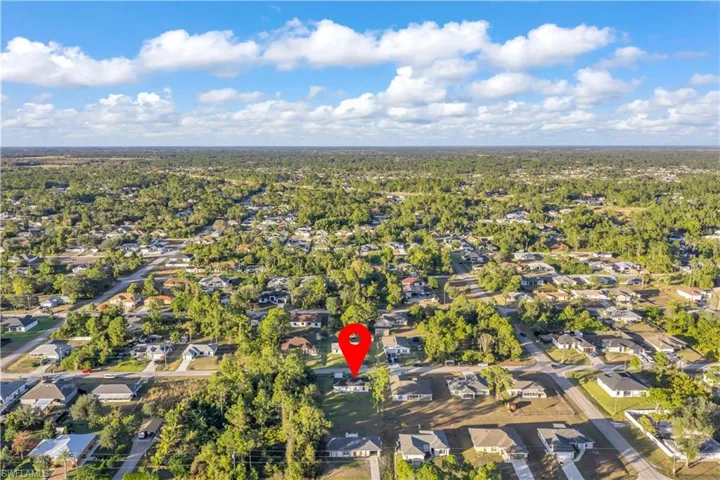 Aerial view of property's location with nearby suburban area