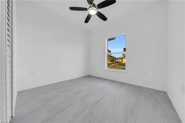 Empty room featuring a ceiling fan
