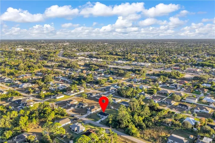 Aerial view of property's location featuring nearby suburban area