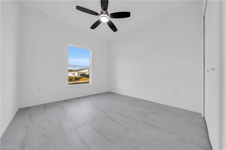 Spare room with ceiling fan