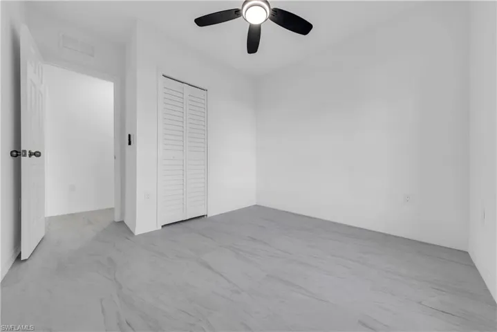 Unfurnished bedroom with a closet and ceiling fan