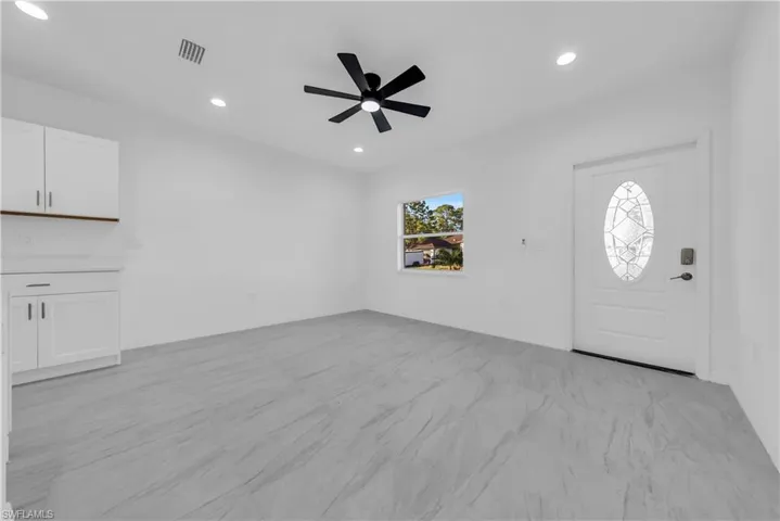 Foyer with recessed lighting and a ceiling fan