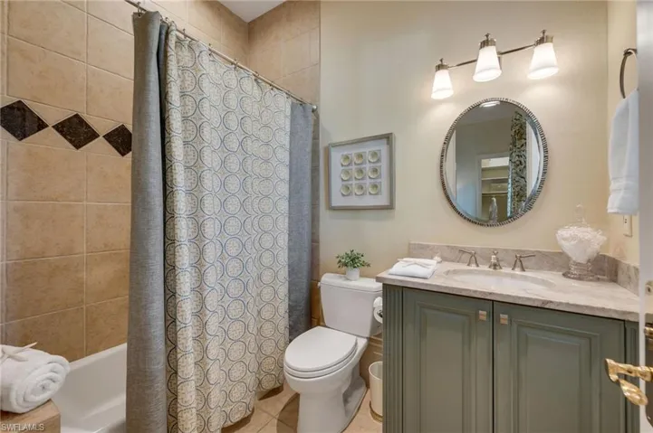Guest bath has updated cabinetry, quartzite counters, and new light fixtures.  The tub is perfect for grand babies!