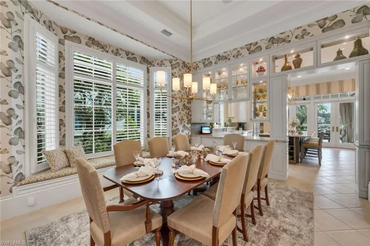 Just imaging the memorable dinners you will have in this beautifully-updated dining room, with new fixtures, custom window seat, and glass cabinetry that blends the two rooms together.
