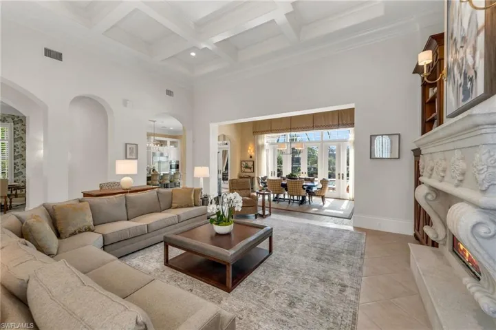 The large living room boasts of impressive, 16' coffered ceilings...