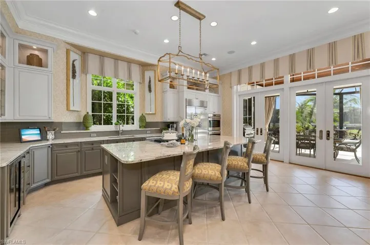 The updated kitchen has a fabulous, large island, and custom cabinetry for abundant storage.