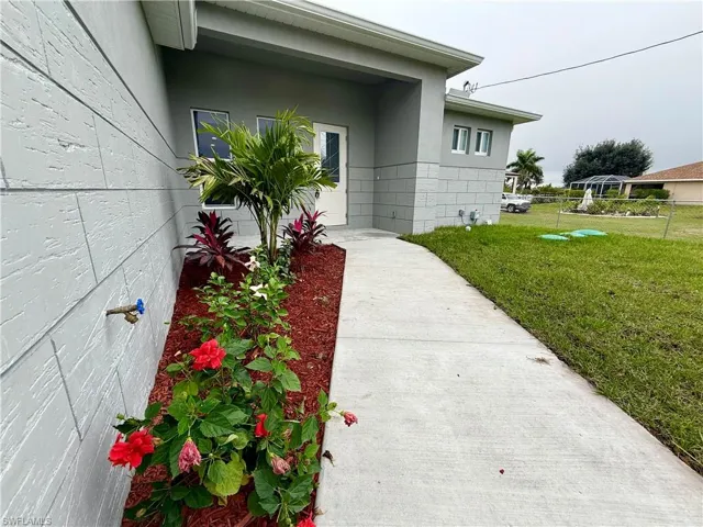 View of exterior entry with a yard