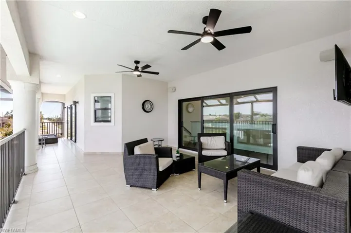 View of patio featuring an outdoor hangout area and ceiling fan