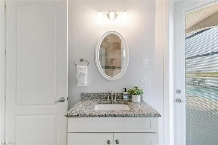 Bathroom featuring vanity and a tile shower