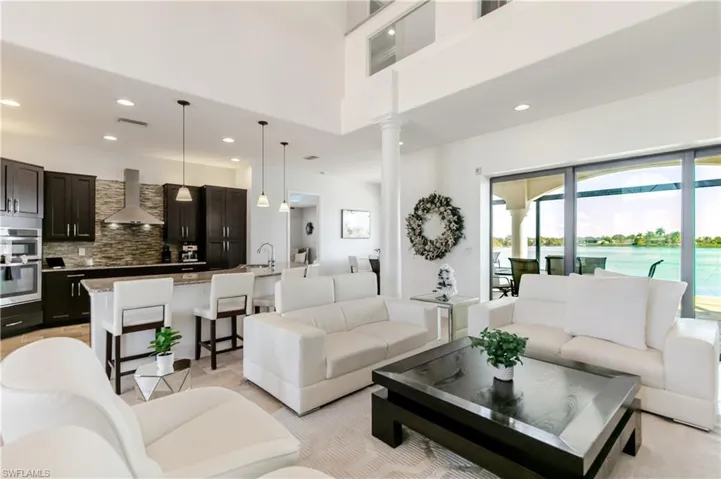Living room with recessed lighting and a high ceiling