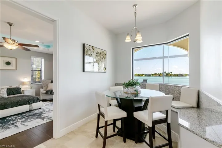 DiningNook area featuring a water view, suspended lighting, and ceiling fan