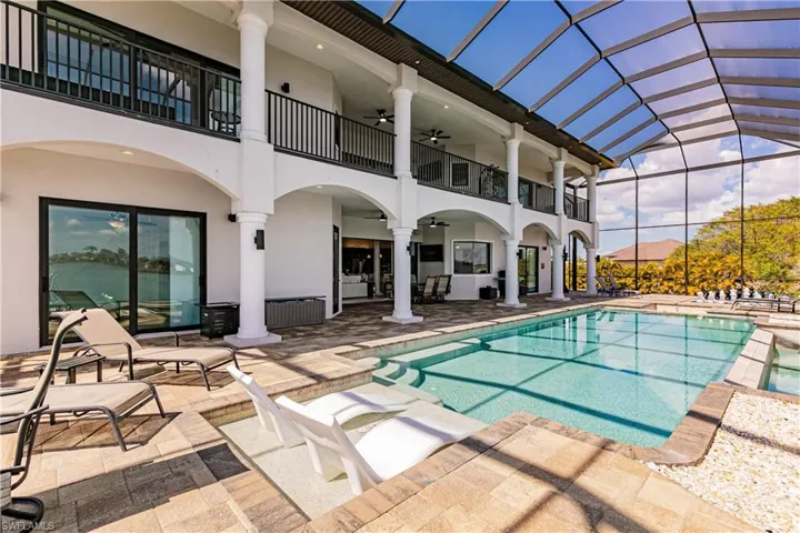 Integrated pool / spa featuring a patio area and a lanai