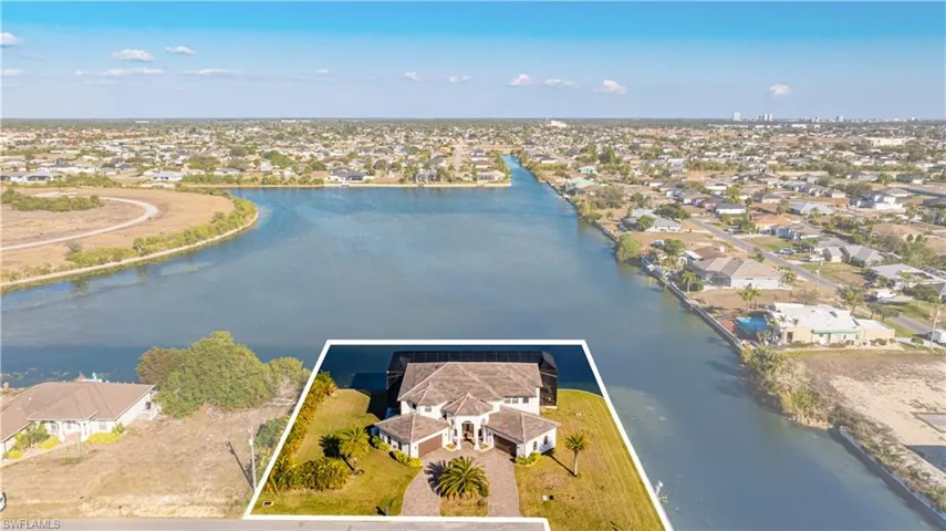 Aerial view of residential area featuring a large body of water