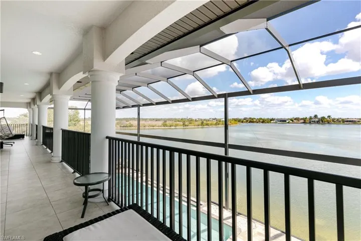 Balcony featuring a water view and a sunroom