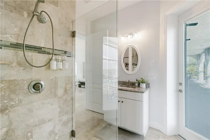 Full bathroom featuring vanity and tiled shower