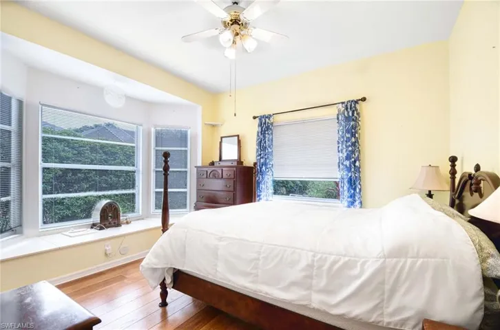 Bedroom with hardwood / wood-style floors and ceiling fan