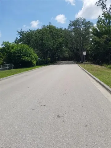 View of asphalt road with curbs and traffic signs