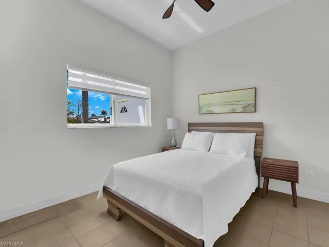Bedroom featuring a ceiling fan and light tile patterned floors