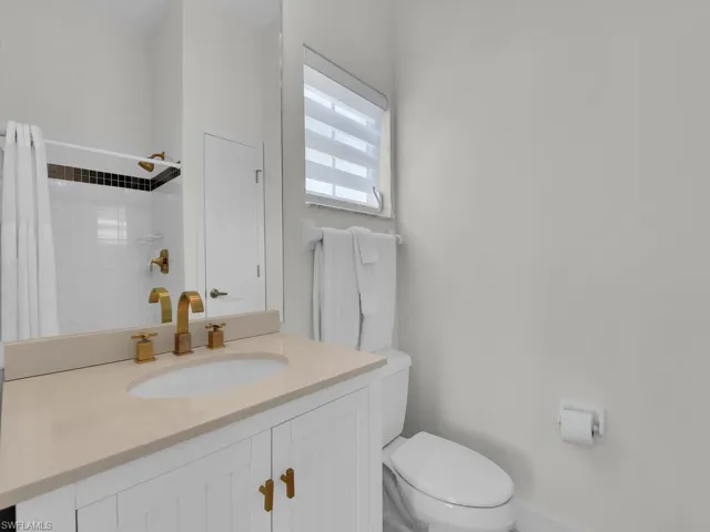 Full bathroom with vanity and a shower with curtain