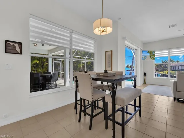 Dining room with a sunroom, plenty of natural light, and light tile patterned flooring