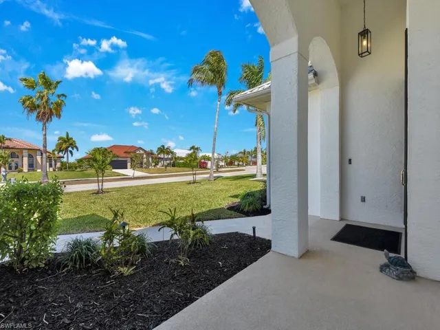 Porch featuring a lawn