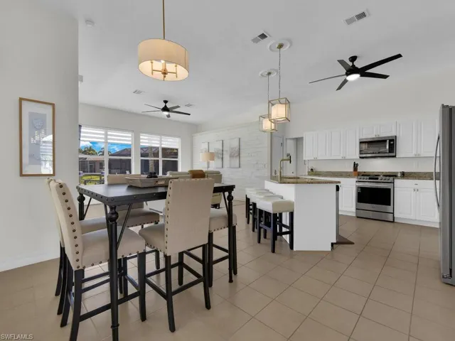Dining area featuring ceiling fan and light tile patterned floors