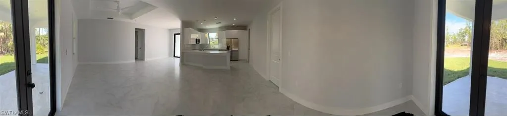 Hall featuring recessed lighting, marble finish floor, and baseboards