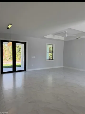 Spare room featuring a ceiling fan, marble finish floor, visible vents, and baseboards