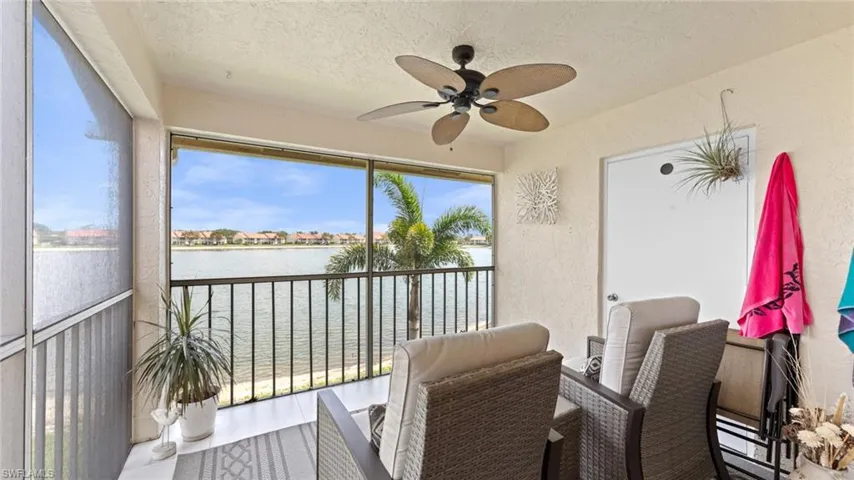 Sunroom featuring a water view