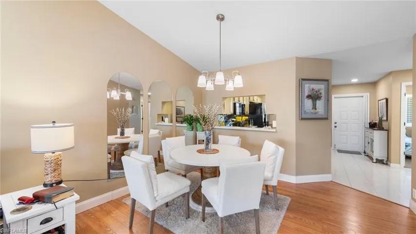 Dining area featuring a chandelier, baseboards, and light wood-style floors