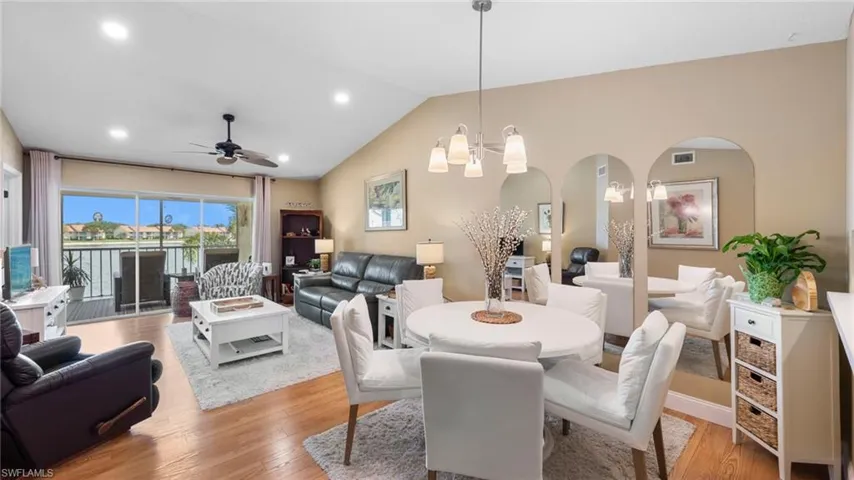Dining room featuring ceiling fan, light wood-style flooring, arched walkways, recessed lighting, and vaulted ceiling