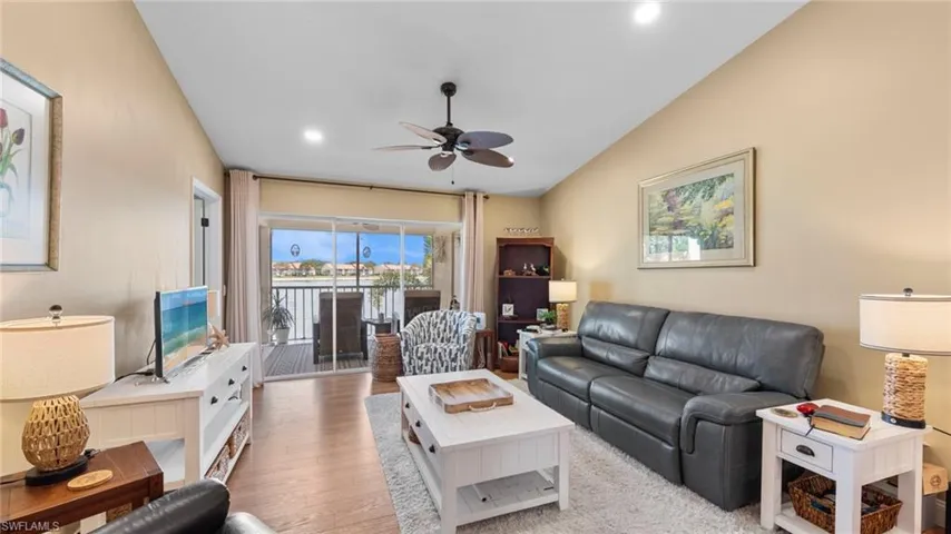 Living area featuring ceiling fan, wood finished floors, vaulted ceiling, and recessed lighting