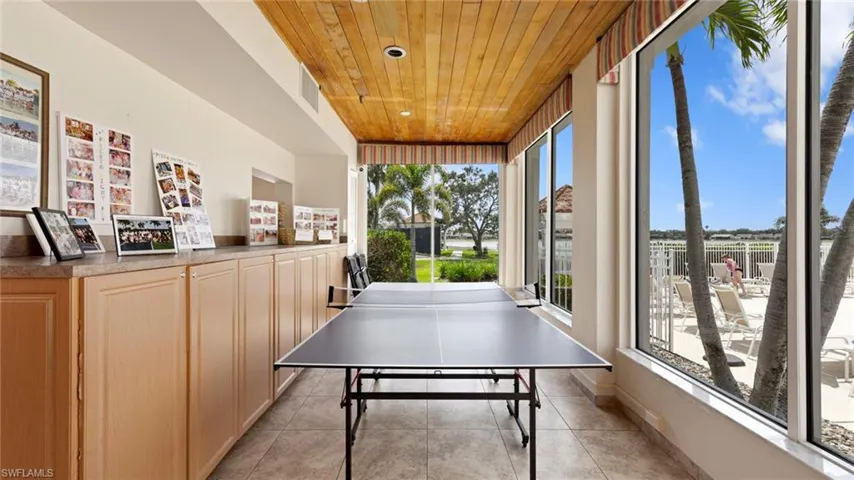 Recreation room with wood ceiling and light tile patterned flooring