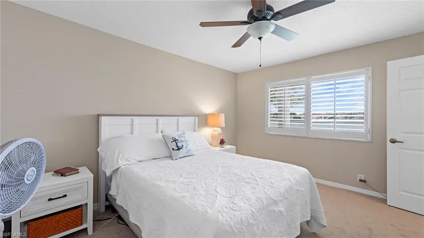 Bedroom with carpet, baseboards, and ceiling fan