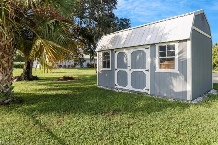 View of outbuilding featuring a yard